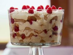 a close up of a cake with raspberries on top