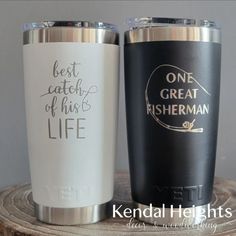 two personalized tumblers sitting on top of a tree stump