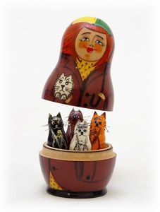 an image of a wooden doll with cats in it