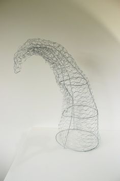 a wire sculpture sitting on top of a white table