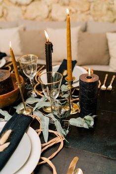 the table is set with candles and place settings