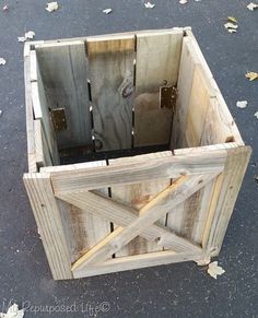 a wooden box sitting on top of a cement ground