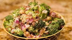 a bowl filled with broccoli and onions on top of a granite countertop