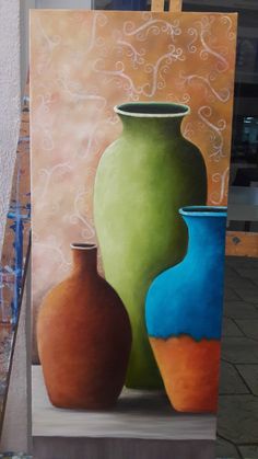 a painting of three vases sitting on a easel in front of a wall