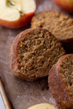 apples and cinnamon muffins on a baking sheet with two pieces cut off the side