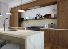 a kitchen with wooden cabinets and marble counter tops, two stools at the island