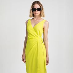 V-neck wrap dress in fluid, wrinkle-free fabric for casual and formal occasions. The vibrant neon colour adds a bold touch to your outfit and will make you stand out from the crowd. Featuring a stylish v-neckline and elongated side straps, this dress combines elegance with modern flair. 100% polyester  Made in Budapest.  Wash at or below 30°C. Do not bleach. Do not tumble dry. Iron at low temperature (110 °C). Modern V-neck Spring Dresses, Summer Evening Wrap Dress With Surplice Neckline, Modern V-neck Summer Dress, Summer Draped Wrap Dress, Fitted Draped Wrap Dress For Summer, Summer Cocktail Midi Wrap Dress, Green Summer Evening Wrap Dress, Green Evening Wrap Dress For Summer, Summer Cocktail Midi Dress With Surplice Neckline