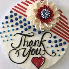 a thank you cake decorated with an american flag and a red white and blue flower