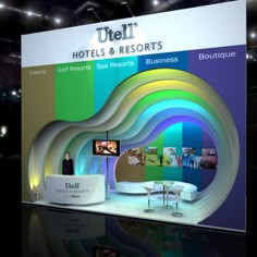 an exhibition stand with a large display on it's side, displaying hotel and resort information