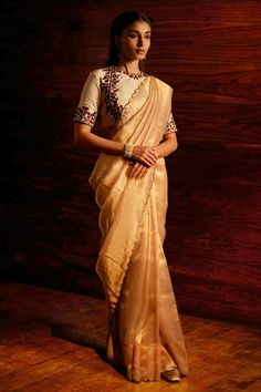 Gold silk tissue woven saree with metallic sequin embroidered scalloped borders. Comes with unstitched blouse piece.
Components: 2
Pattern: Woven and Embroidered 
Type Of Work: Sequin Work
Fabric: Silk Tissue
Color: Gold
Other Details: 
Note: The stitched blouse worn by the model is not for sale
Occasion: Wedding,Reception - Aza Fashions Luxury Traditional Wear In Tissue Silk With Weaving Work, Festive Cotton Silk Pre-draped Saree For Celebration, Gold Tussar Silk Pre-draped Saree For Reception, Gold Cotton Silk Pre-draped Saree For Reception, Festive Embroidered Slub Silk Pre-draped Saree, Elegant Resham Embroidered Cotton Silk Blouse Piece, Festive Embroidered Cotton Silk Pre-draped Saree, Festive Pre-draped Transitional Saree, Bollywood Style Raw Silk Blouse With Sheer Dupatta