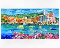 a painting of a city by the water with mountains in the background and flowers growing on the shore