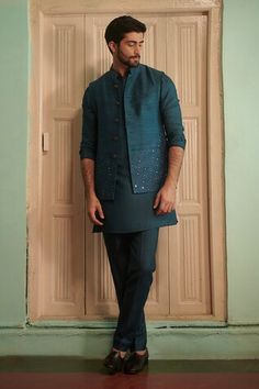 Teal blue silk bundi with sequins hand embroidery. - Aza Fashions Festive Silk Nehru Jacket For Party, Fitted Chanderi Nehru Jacket For Wedding, Transitional Chanderi Nehru Jacket With Mirror Work, Eid Nehru Jacket With Mirror Work In Raw Silk, Eid Raw Silk Nehru Jacket With Mirror Work, Eid Nehru Jacket In Raw Silk With Mirror Work, Traditional Nehru Jacket With Mirror Work In Raw Silk, Traditional Raw Silk Nehru Jacket With Mirror Work, Fitted Nehru Jacket With Mirror Work For Festive Season