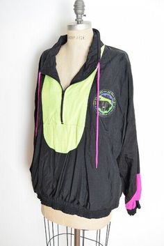 huncamuncavintage Description: This is an awesome vintage windbreaker pull over from the early 90s. It's made of swishy woven nylon (unlined) that's black with neon yellow and pink trim. This jacket has side pockets, an elastic waist, and it closes halfway up the chest with a zipper. Excellent condition Label: Slazenger Measurements: This jacket is labeled a size large, but please go by the measurements. Chest: 54" Waist: 36-44" Hips: Underarm to hem: 15" Shoulder to hem: 28" Sleeve length: 19" Black Retro Windbreaker, Black Nylon Tops For Streetwear, Black Long Sleeve Retro Windbreaker, Retro Black Hooded Windbreaker, Retro Black Windbreaker For Outdoors, Retro Black Windbreaker For Outdoor, Nylon Sportswear Tops For Streetwear, Nylon Tops For Streetwear In Sportswear Style, Black Sportswear Windbreaker For Spring