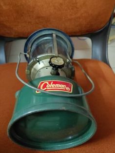 an old style camping stove sitting on top of a chair