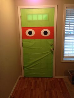 a door decorated to look like a teenage mutant with googly eyes on it's face