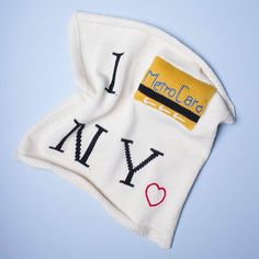 i love new york written on the back of a white knitted hat with red and blue hearts