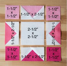 four pieces of pink and white paper with numbers on them sitting on top of a wooden table