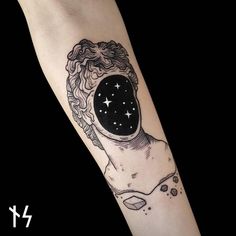 a woman's arm with a space tattoo on it