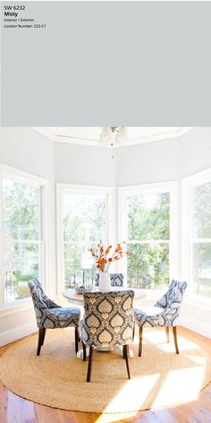 the sun shines through the windows in this dining room with chairs and a round table