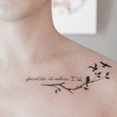 a man with a tattoo on his chest that reads, and birds are sitting on the branch