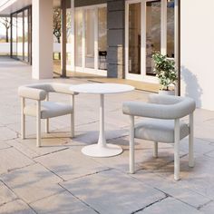 two chairs and a table sitting on the side of a building next to each other