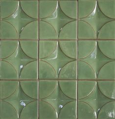 a green tile wall with circles on it