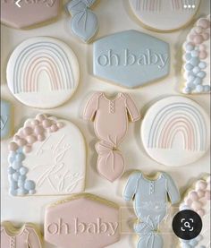 baby shower cookies are arranged in pastel colors