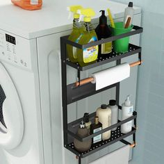 a washer and dryer in a bathroom next to each other with cleaning supplies on the rack