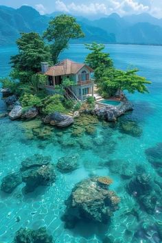 an island with a house on it in the middle of the ocean, surrounded by rocks and trees