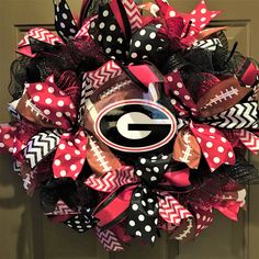 the university of georgia football wreath is decorated with red, black and white polka dots