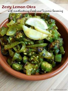 a brown bowl filled with green vegetables on top of a wooden table