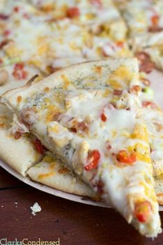 several slices of pizza sitting on top of a white plate