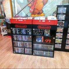 the nintendo store has two shelves with games on them and there are also video games