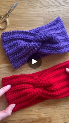 two crocheted headbands on top of a wooden table next to scissors