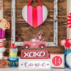 valentine's day decorations displayed in front of a wooden wall with hearts and flowers