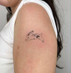 a woman's arm with a tattoo of a dog on the back of it