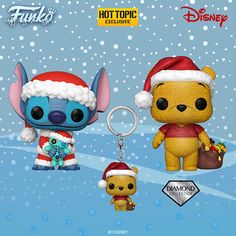 two funky toys are on display in front of a snow covered background, one is wearing a santa hat and the other has a stuffed animal keychain