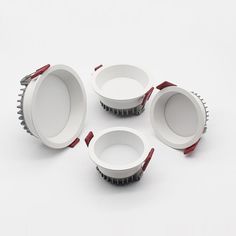 four dim downlights on white background with red trimmings and wire around them