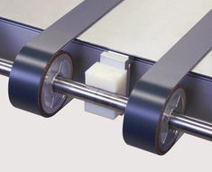 two rolls of tape are attached to the side of a metal structure with rollers