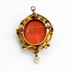 "Antique 14 K (.585) yellow gold combination of a brooch and pendant in Art Nouveau designs, having Coral cameo centerpiece, featuring carved female portrait. Frame is accented with Baroque Pearls. This majestic piece is 2 1/4\" long, 1 1/2\" wide and weighs 18.7 grams. EA518" Baroque Yellow Gold Brooch Jewelry, Baroque Yellow Gold Brooch, Victorian Pendant Brooches With Cabochon, Art Nouveau Gold Brooch With Cabochon, Yellow Gold Cabochon Pendant Brooch, Antique Pendant Brooch With Cabochon, Art Nouveau Oval Cameo Jewelry, Elegant Ceremonial Cameo Jewelry, Gold Cameo Jewelry In Art Nouveau Style