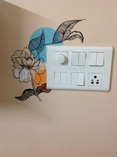 a white light switch sitting on top of a wall next to a flower painted mural