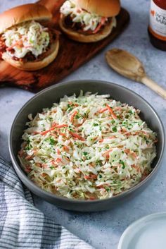 coleslaw slaw in a bowl next to two burgers