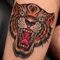 a close up of a tattoo with a tiger's face on the arm and chest