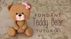 a crocheted teddy bear sitting on top of a rug with the words fondant teddy bear