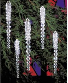 four crystal stick ornaments hanging from a tree