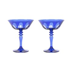 two blue glass goblets sitting side by side on a white background, one is empty