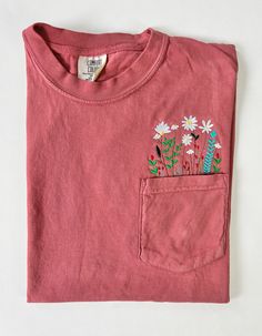 Wildflower Pocket Tees – Peach Marketplace Pink T-shirt With Embroidered Graphics And Relaxed Fit, Pink T-shirt With Embroidered Graphics In Relaxed Fit, Pink Relaxed Fit T-shirt With Embroidered Graphics, Pink Embroidered Cotton T-shirt, Pink Cotton T-shirt With Embroidered Graphics, Red Cotton Tops With Embroidered Graphics, Red Cotton Top With Embroidered Graphics, Casual Red T-shirt With Floral Embroidery, Red Cotton T-shirt With Floral Embroidery