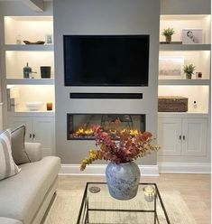 a living room filled with furniture and a flat screen tv mounted on the wall above a fireplace