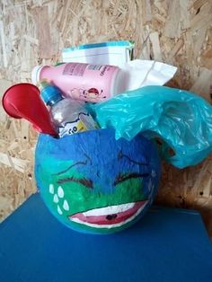 a toothbrush holder made to look like a clown's head with mouth and nose painted on it