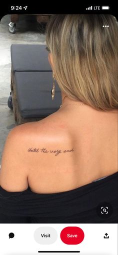 the back of a woman's shoulder with an inscription on it that reads, and she